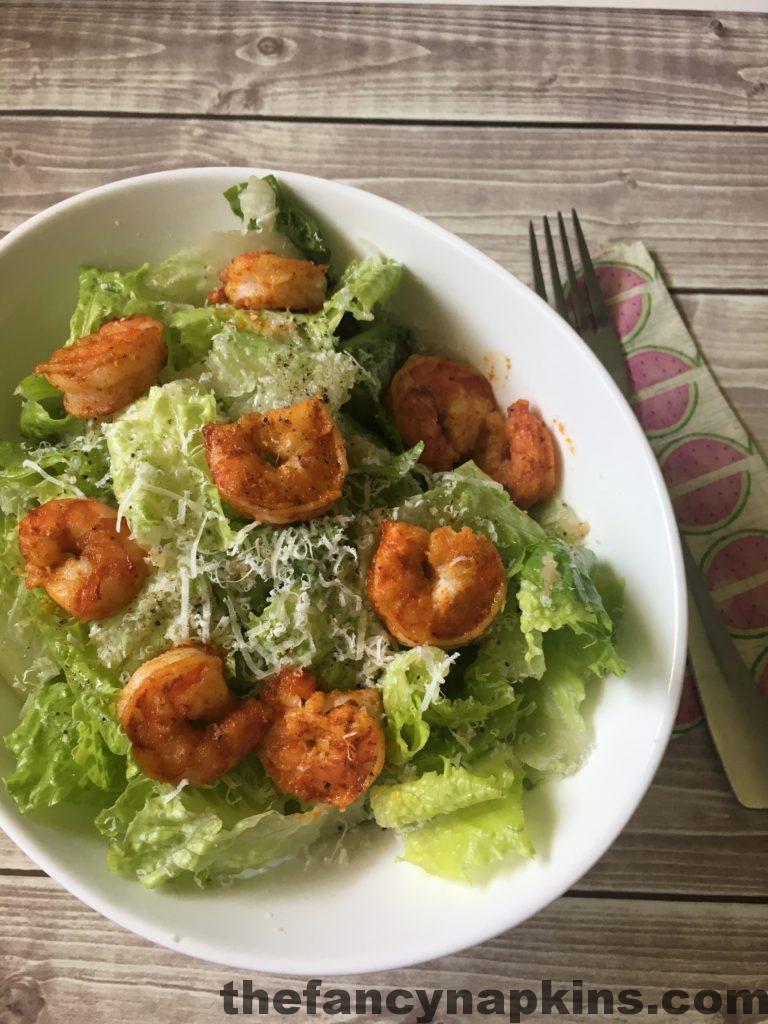 Cajun shrimp cesar salad with spicy tiger shrimp which have been pan fried. Crisp romaine lettuce dressed with Fancy Napkins' cesar dressing. All topped with freshly grated parmesan cheese